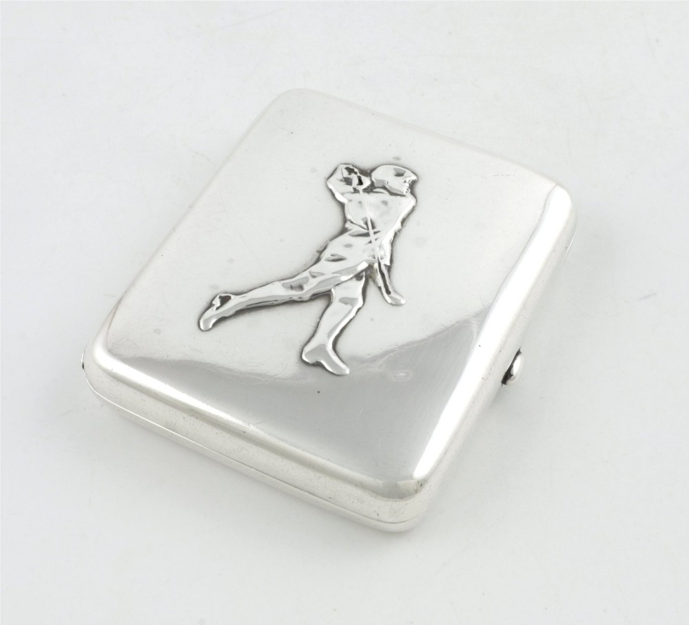 An Edwardian sterling silver cigarette case featuring an embossed relief figure of a golfer in mid-swing on the front cover. View III