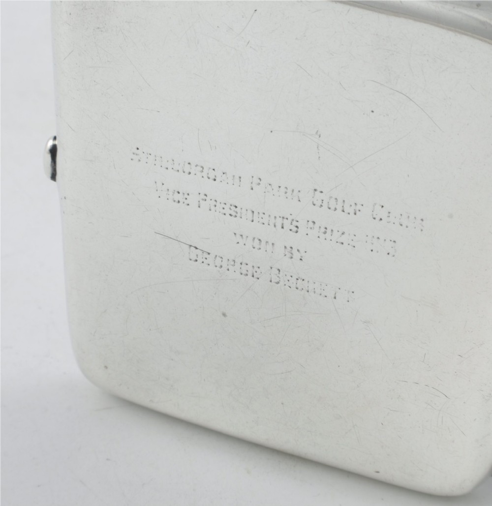 An Edwardian sterling silver cigarette case featuring an embossed relief figure of a golfer in mid-swing on the front cover. View VI