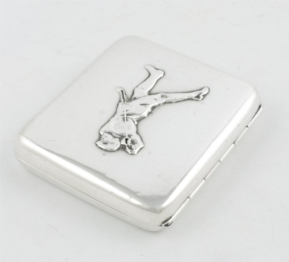 An Edwardian sterling silver cigarette case featuring an embossed relief figure of a golfer in mid-swing on the front cover. View VIII