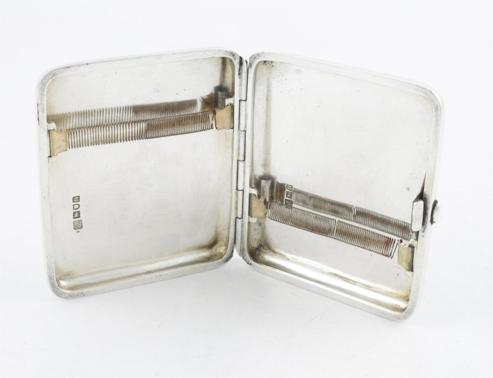 An Edwardian sterling silver cigarette case featuring an embossed relief figure of a golfer in mid-swing on the front cover. View IX
