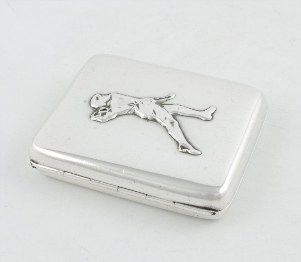 An Edwardian sterling silver cigarette case featuring an embossed relief figure of a golfer in mid-swing on the front cover. View XI