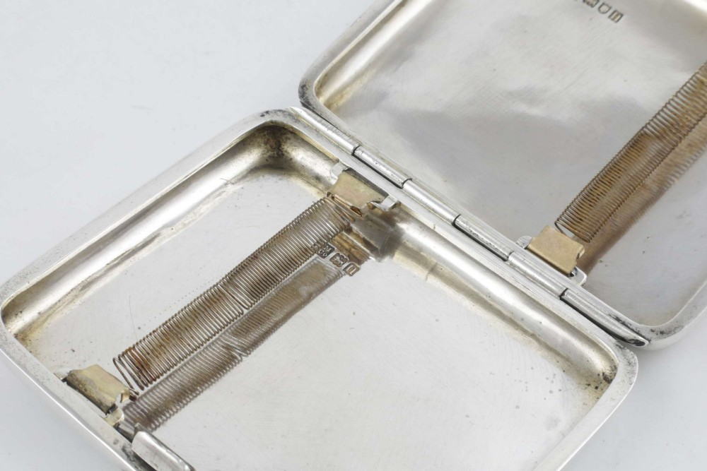 An Edwardian sterling silver cigarette case featuring an embossed relief figure of a golfer in mid-swing on the front cover. View XII