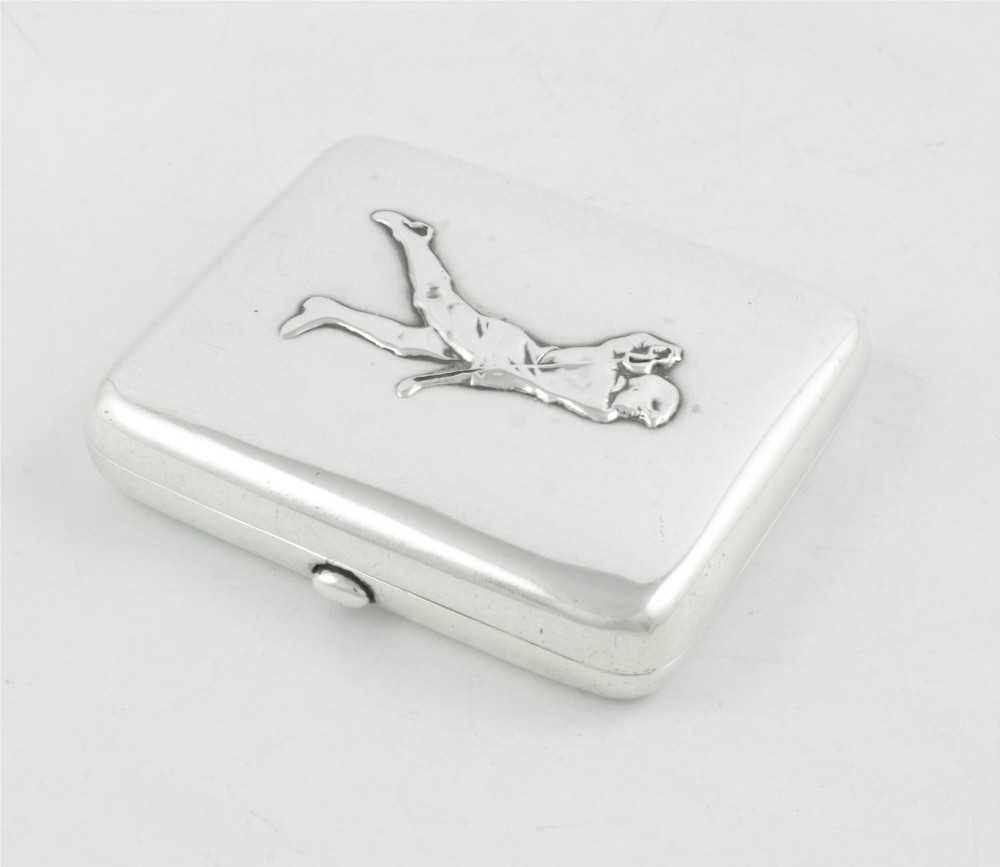 An Edwardian sterling silver cigarette case featuring an embossed relief figure of a golfer in mid-swing on the front cover. View XIII