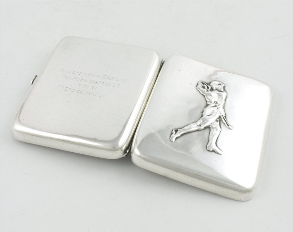 An Edwardian sterling silver cigarette case featuring an embossed relief figure of a golfer in mid-swing on the front cover. View XIV