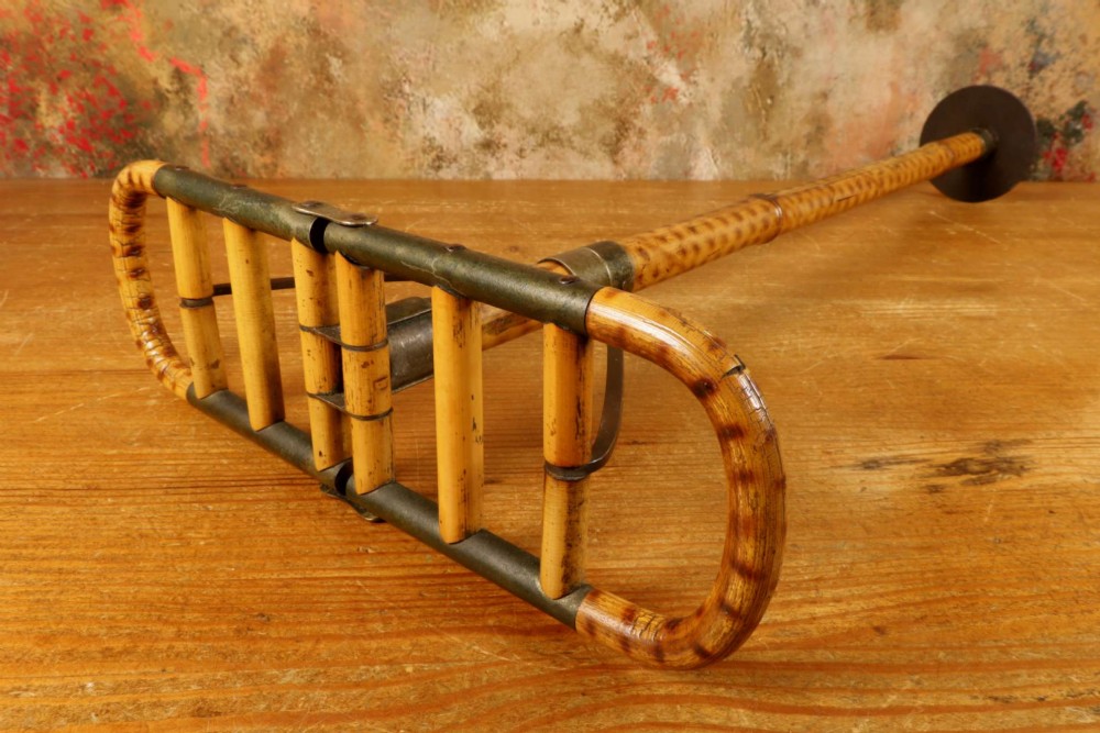 A late 19th-century bamboo shooting stick featuring a folding seat handle, metal support struts, and a spiked metal base. View III