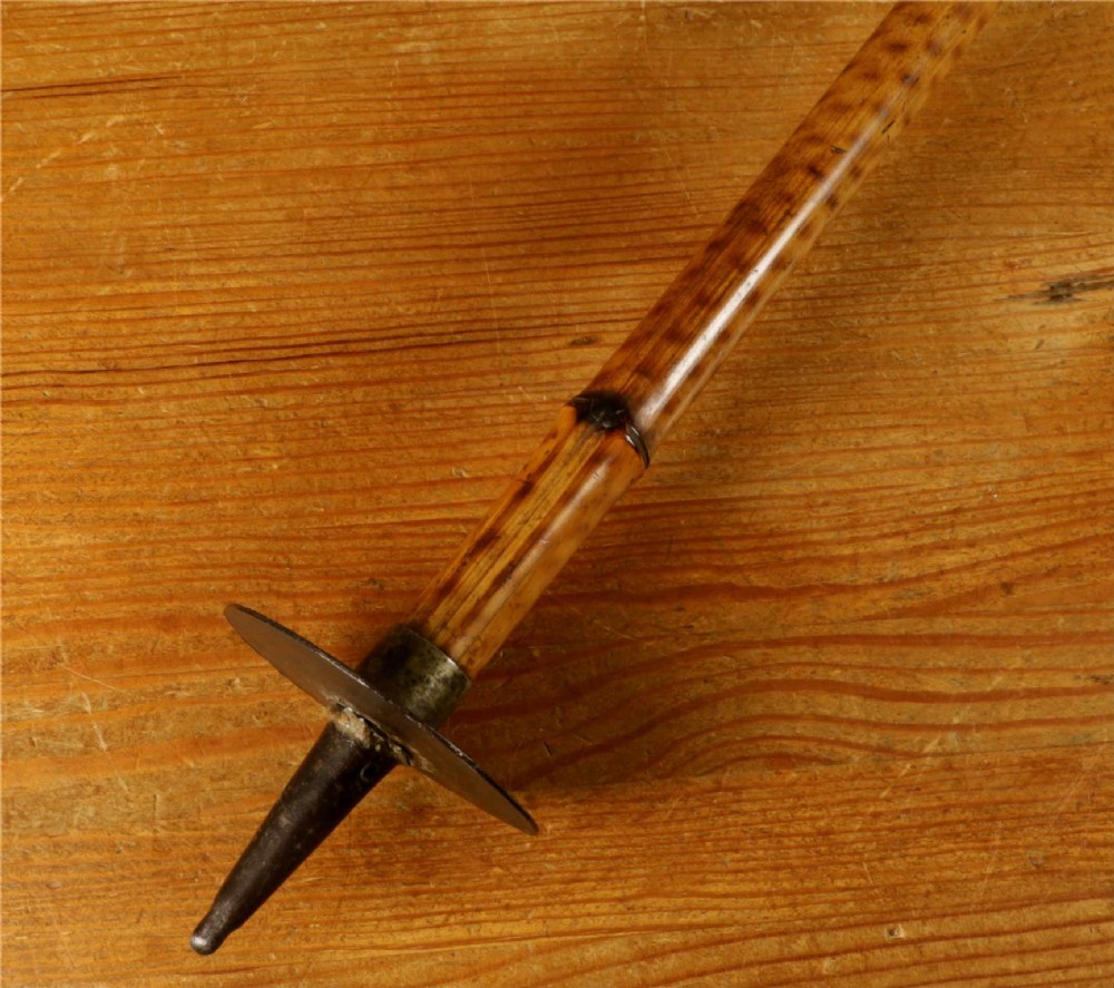 A late 19th-century bamboo shooting stick featuring a folding seat handle, metal support struts, and a spiked metal base. View V