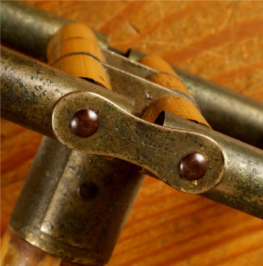 A late 19th-century bamboo shooting stick featuring a folding seat handle, metal support struts, and a spiked metal base. View VII