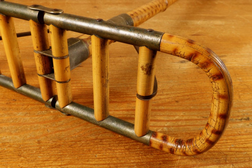 A late 19th-century bamboo shooting stick featuring a folding seat handle, metal support struts, and a spiked metal base. View VIII