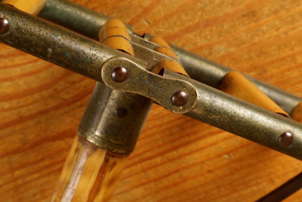 A late 19th-century bamboo shooting stick featuring a folding seat handle, metal support struts, and a spiked metal base. View XI