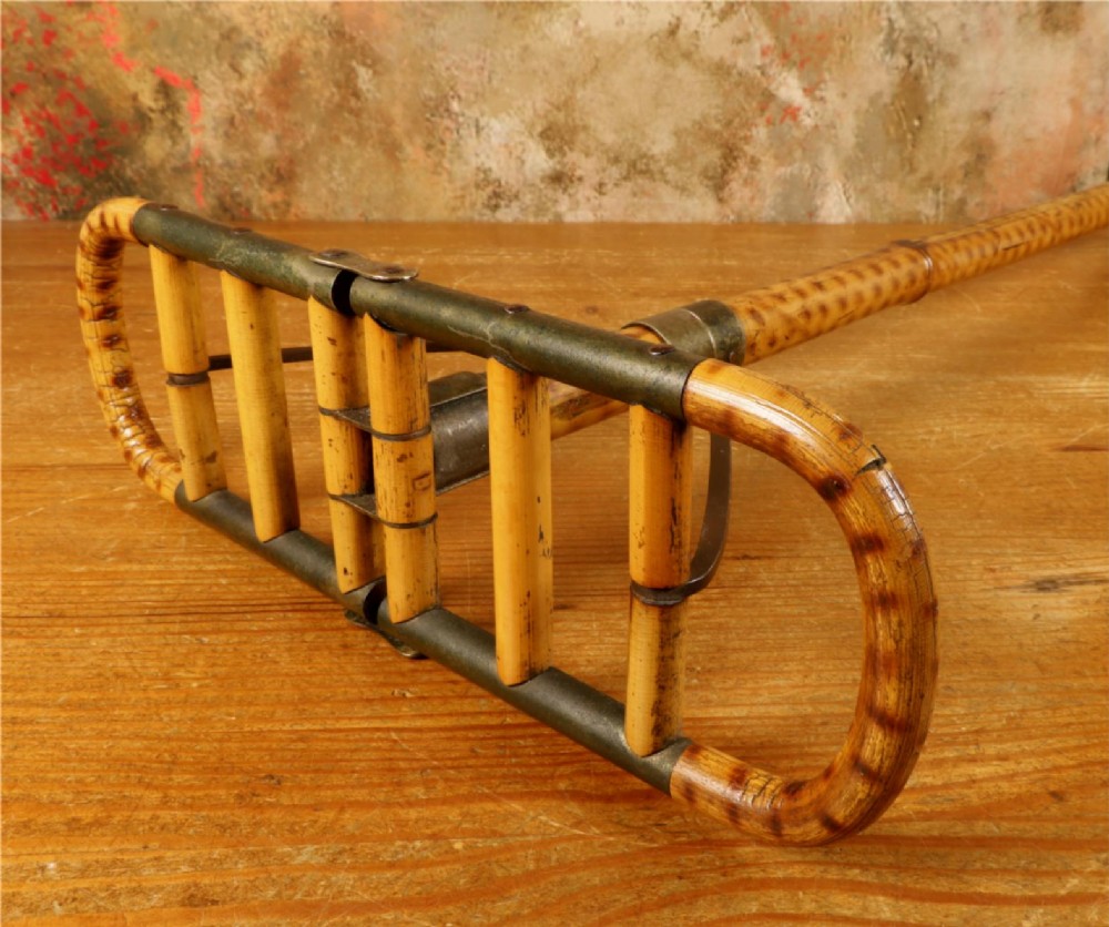 A late 19th-century bamboo shooting stick featuring a folding seat handle, metal support struts, and a spiked metal base. View XIV