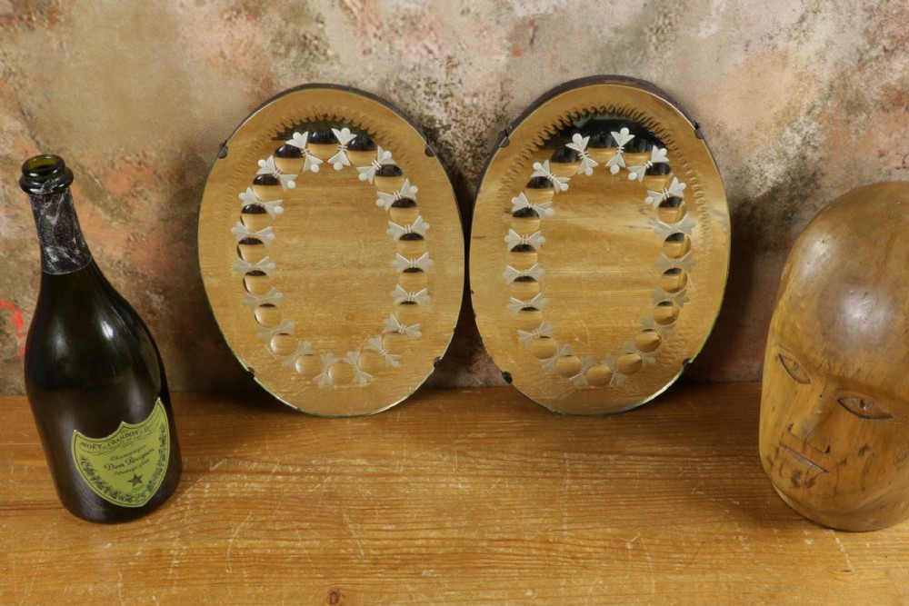 A pair of oval glass sorcerer mirrors featuring central dark reflections surrounded by a border of etched botanical motifs and raised convex glass lenses. View II