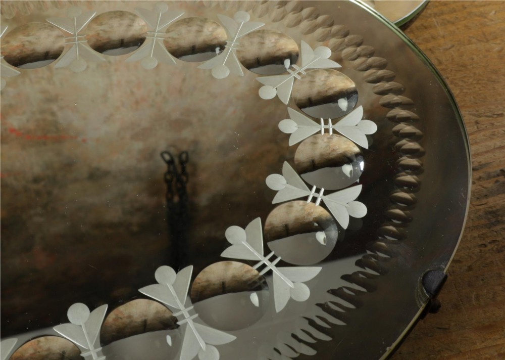 A pair of oval glass sorcerer mirrors featuring central dark reflections surrounded by a border of etched botanical motifs and raised convex glass lenses. View XI