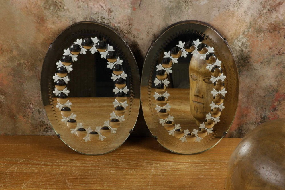 A pair of oval glass sorcerer mirrors featuring central dark reflections surrounded by a border of etched botanical motifs and raised convex glass lenses. View XV