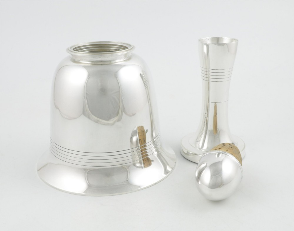 A silver plated novelty cocktail shaker in the shape of a handbell with a smooth turned handle and incised line detailing. View VIII