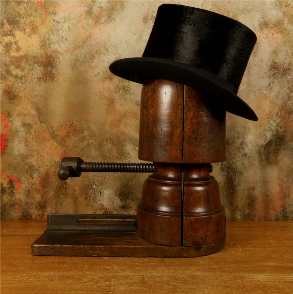 An antique French milliners hat stretcher crafted from dark polished wood with a split head block and an adjustable iron turn-screw mechanism set on a flat timber base. View VIII
