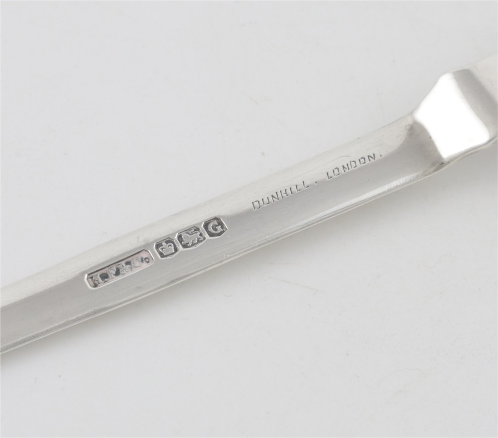 A vintage hallmarked sterling silver letter opener featuring an engine-turned handle casing with an integrated folding knife blade. View V