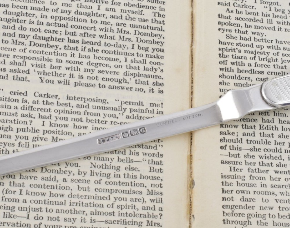 A vintage hallmarked sterling silver letter opener featuring an engine-turned handle casing with an integrated folding knife blade. View IX