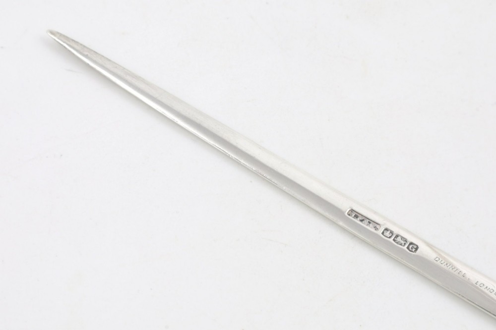 A vintage hallmarked sterling silver letter opener featuring an engine-turned handle casing with an integrated folding knife blade. View XI