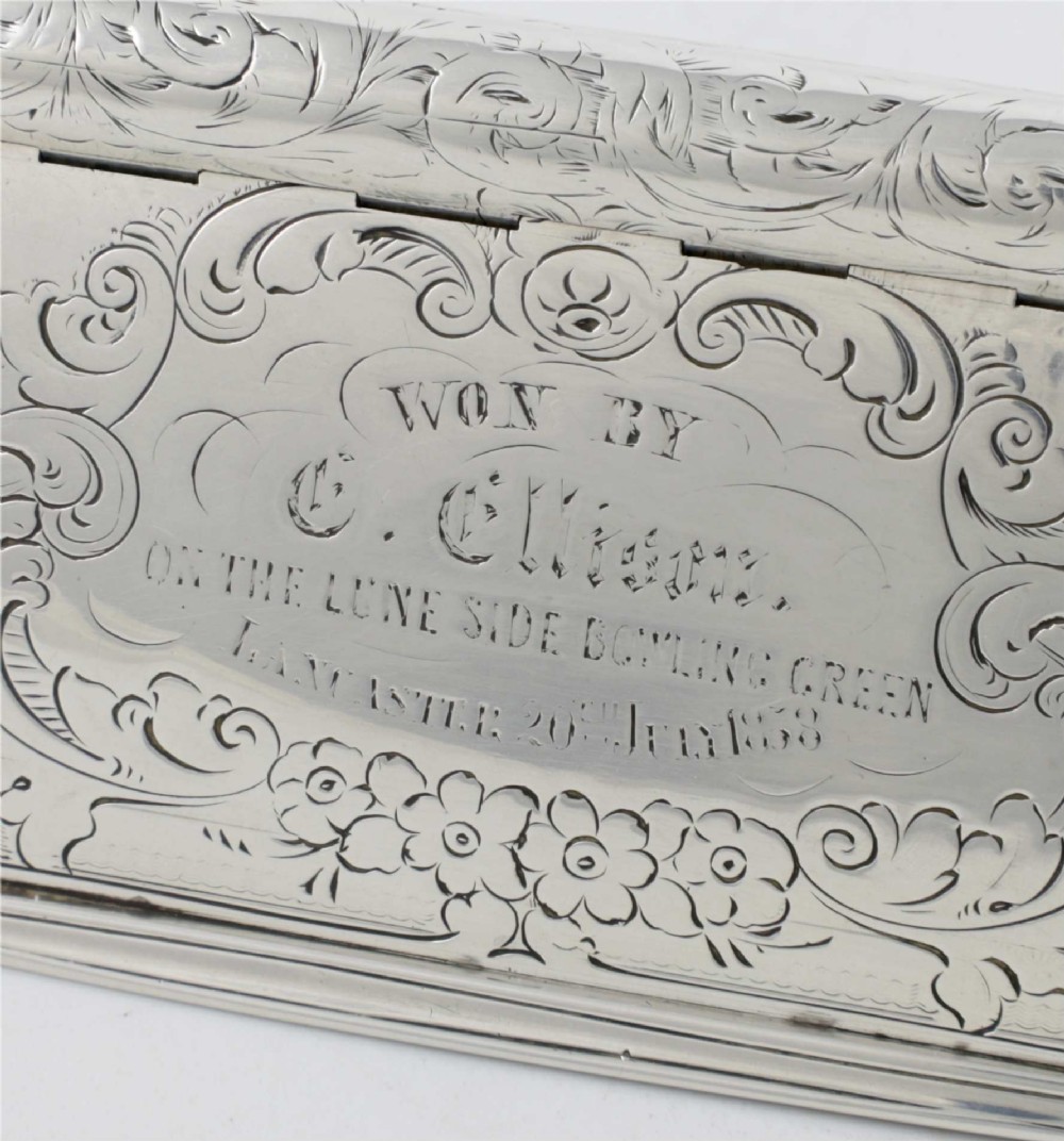 An engraved Victorian sterling silver rectangular snuff box featuring intricate foliate scrollwork and inscribed presentation text. View IV