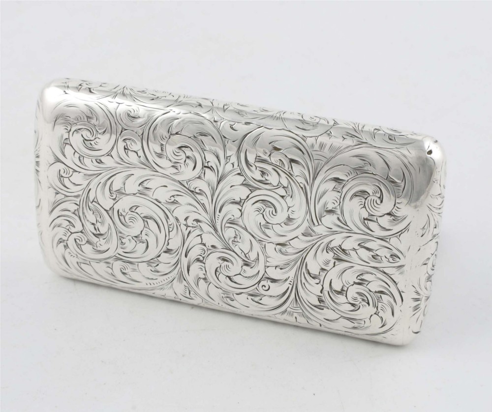An engraved Victorian sterling silver rectangular snuff box featuring intricate foliate scrollwork and inscribed presentation text. View VI