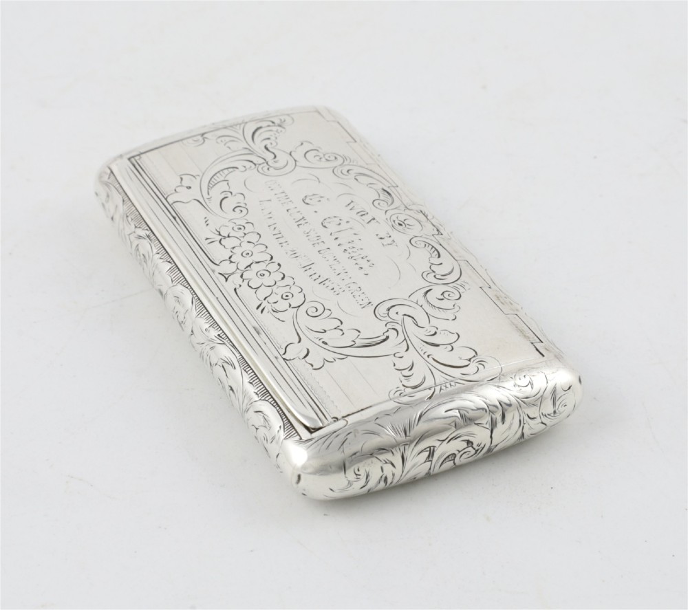 An engraved Victorian sterling silver rectangular snuff box featuring intricate foliate scrollwork and inscribed presentation text. View XII
