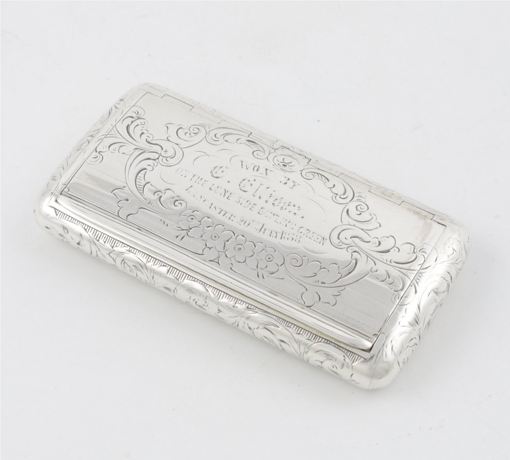 An engraved Victorian sterling silver rectangular snuff box featuring intricate foliate scrollwork and inscribed presentation text. View XIII