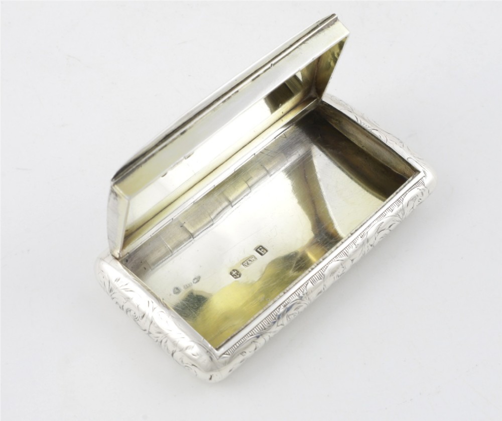 An engraved Victorian sterling silver rectangular snuff box featuring intricate foliate scrollwork and inscribed presentation text. View XIV
