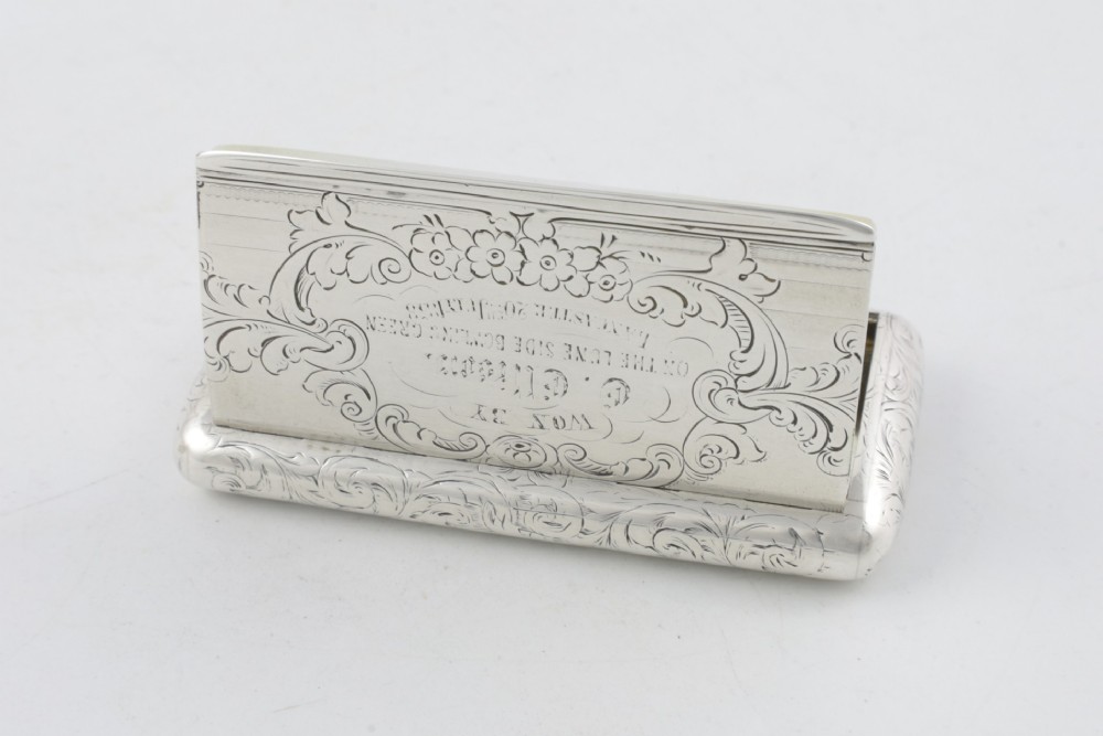 An engraved Victorian sterling silver rectangular snuff box featuring intricate foliate scrollwork and inscribed presentation text. View XV