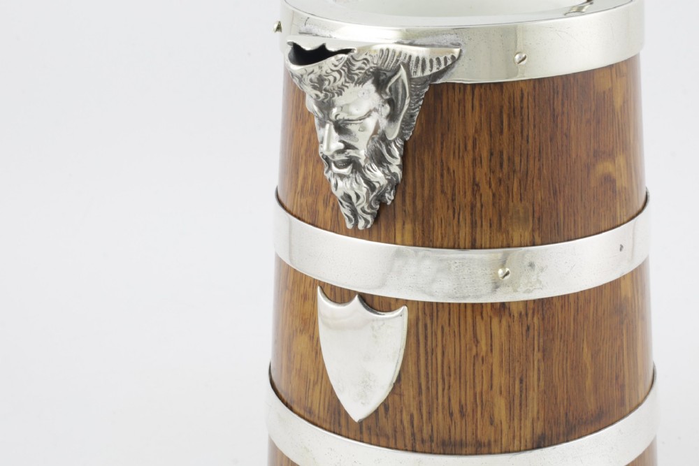 A Victorian coopered oak wine pitcher featuring silver-plated bands, a detailed Bacchus spout, and a hinged lid with a wooden finial. View III