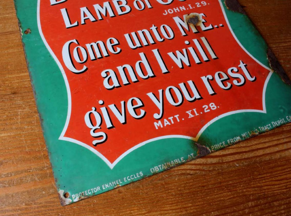 A rectangular vitreous enamel sign with a green background and a red central cartouche displaying white and black printed scripture texts. View IV