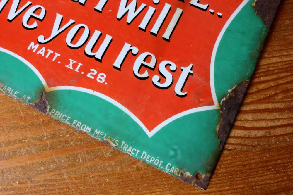 A rectangular vitreous enamel sign with a green background and a red central cartouche displaying white and black printed scripture texts. View VI
