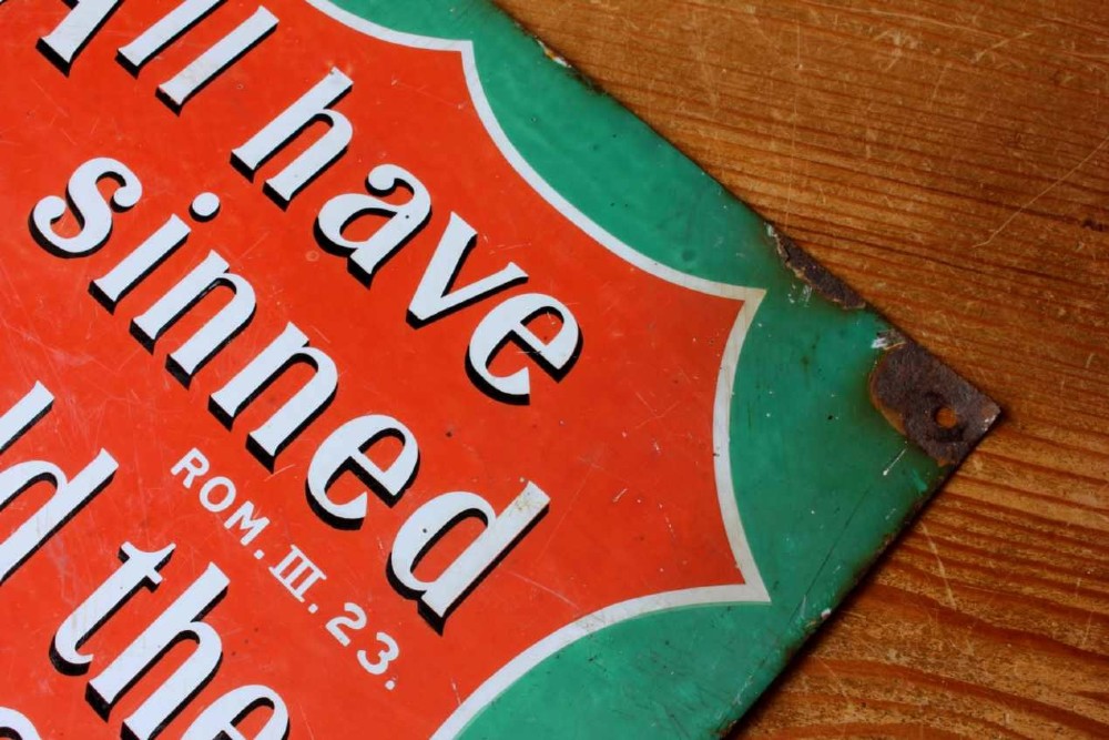A rectangular vitreous enamel sign with a green background and a red central cartouche displaying white and black printed scripture texts. View IX