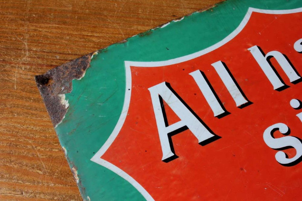 A rectangular vitreous enamel sign with a green background and a red central cartouche displaying white and black printed scripture texts. View X