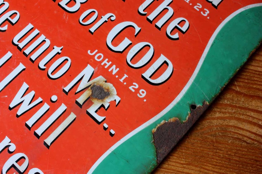 A rectangular vitreous enamel sign with a green background and a red central cartouche displaying white and black printed scripture texts. View XI
