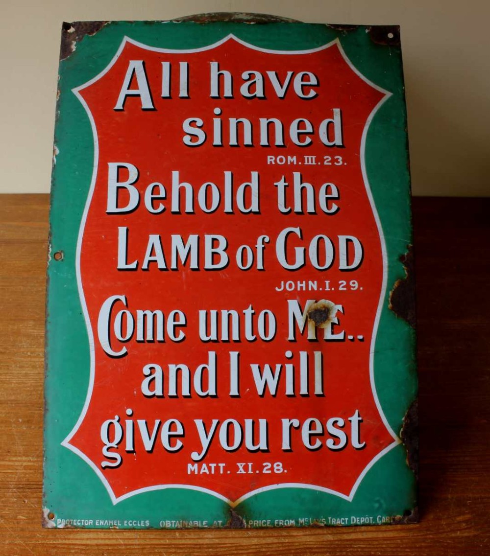 A rectangular vitreous enamel sign with a green background and a red central cartouche displaying white and black printed scripture texts. View XII