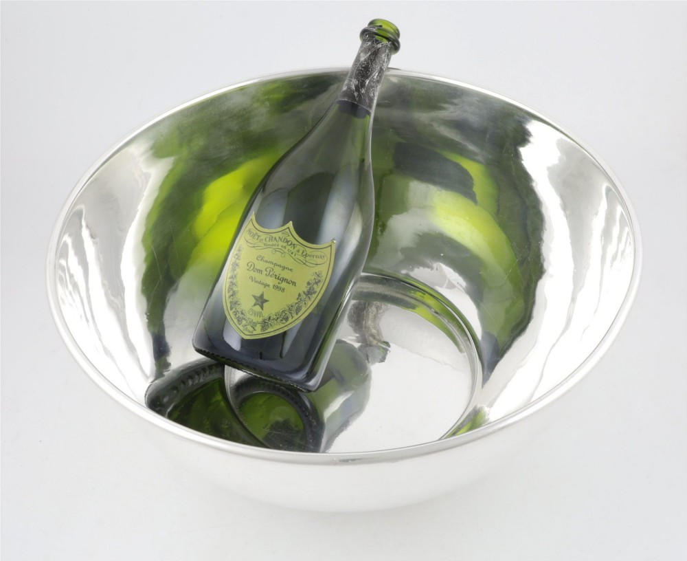 A large polished silver-plated champagne cooler bowl featuring a smooth circular basin, rolled rim, and pedestal base. View IV
