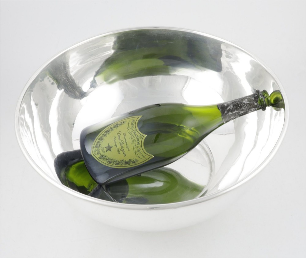 A large polished silver-plated champagne cooler bowl featuring a smooth circular basin, rolled rim, and pedestal base. View VI