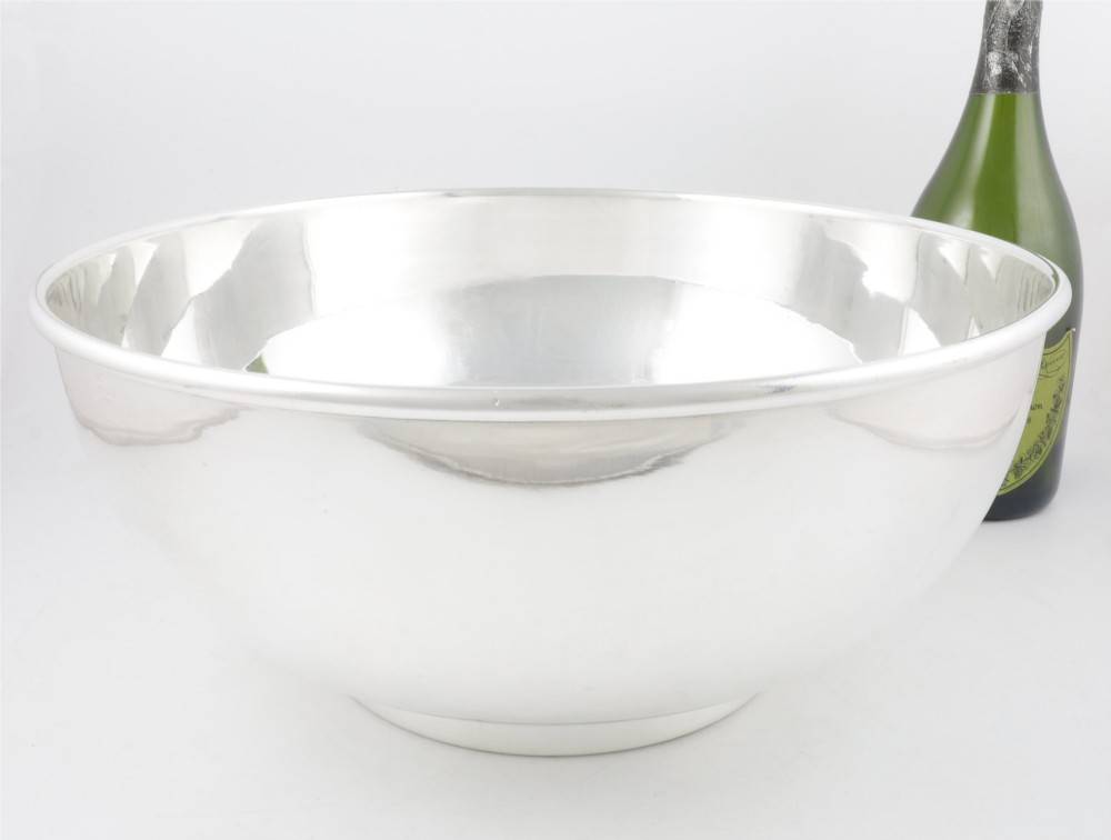 A large polished silver-plated champagne cooler bowl featuring a smooth circular basin, rolled rim, and pedestal base. View XIV