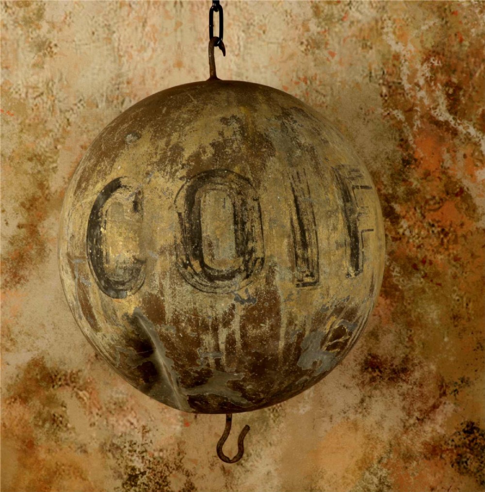 A 19th-century spherical zinc French coiffeur trade sign featuring hand-painted lettering and iron hanging hooks.