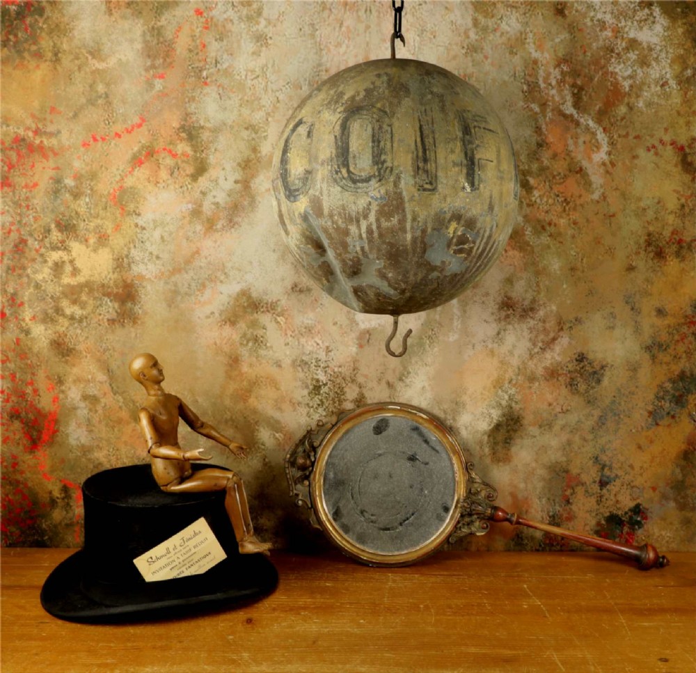 A 19th-century spherical zinc French coiffeur trade sign featuring hand-painted lettering and iron hanging hooks. View II