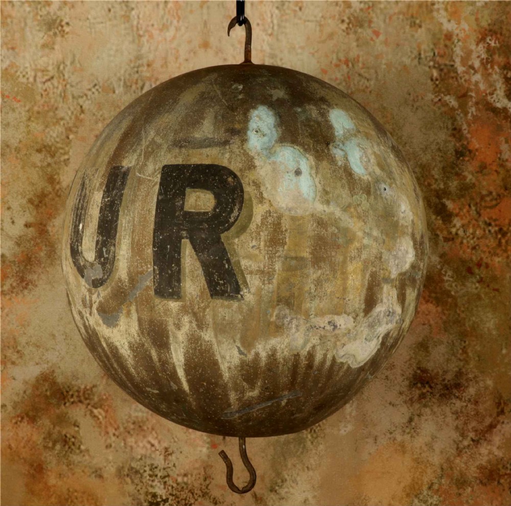 A 19th-century spherical zinc French coiffeur trade sign featuring hand-painted lettering and iron hanging hooks. View VI