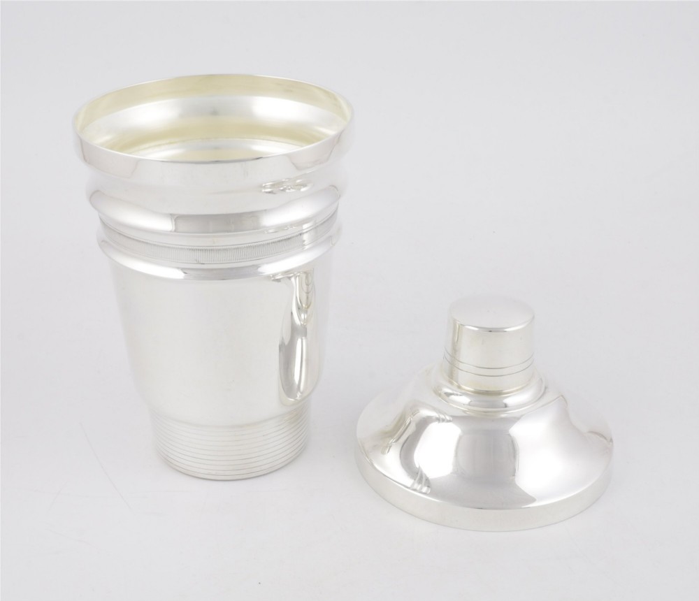A 1930s Art Deco silver-plated cocktail shaker featuring stepped geometric contours and fine engine-turned band details. View IV