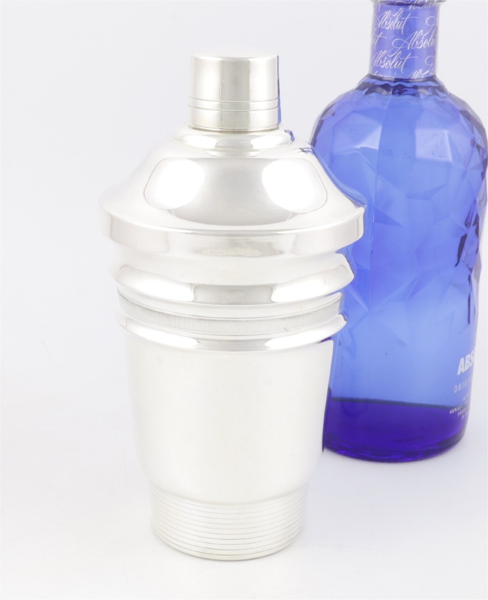 A 1930s Art Deco silver-plated cocktail shaker featuring stepped geometric contours and fine engine-turned band details. View XI