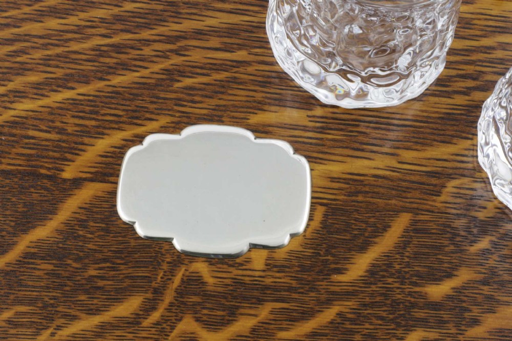 A late Victorian shaped English oak serving tray featuring a silver-plated raised gallery rail, twin wood-mounted handles, and a central blank silver cartouche. View III