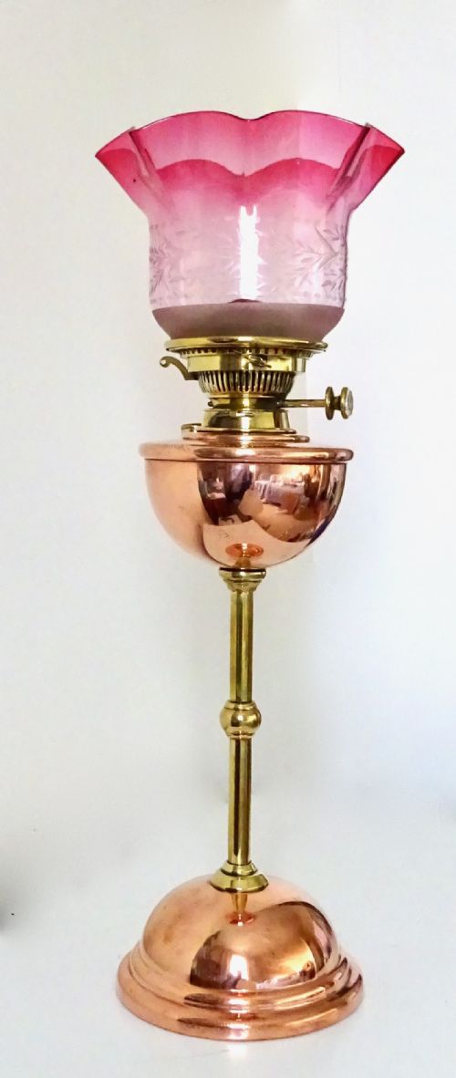 A Benson Oil Lamp with Original Cranberry Shade