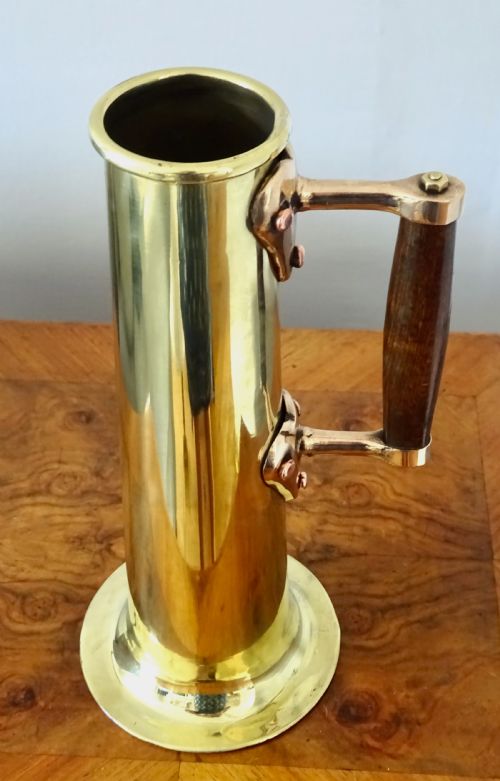 fig 1. A BRASS AND BRONZE HYDROMETER JUG