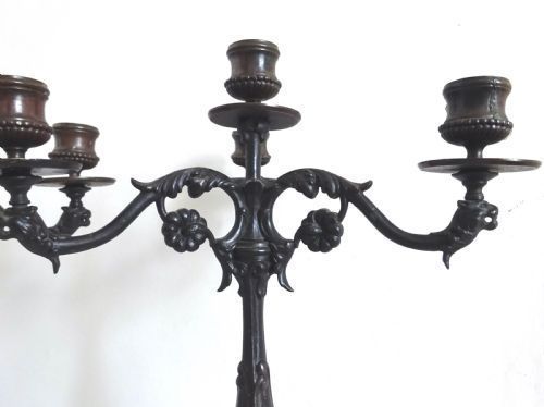 fig 1. A pair of Victorian dark bronze three-light candelabra featuring scrollwork arms, cast detail, and tripod bases.