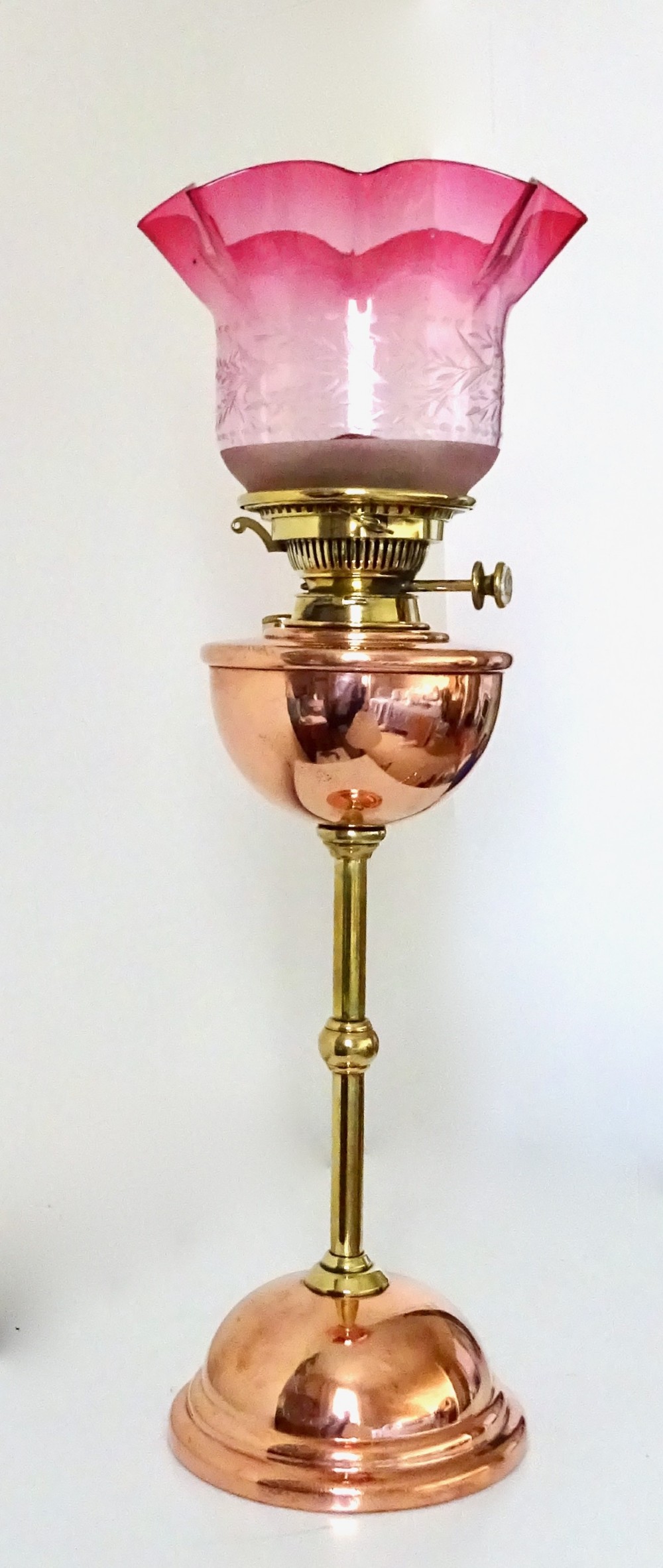 A BENSON OIL LAMP WITH ORIGINAL CRANBERRY SHADE