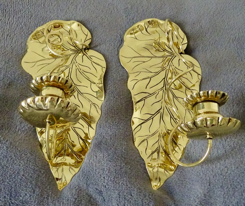 A PAIR OF ART NOUVEAU BRASS CANDLE SCONCES