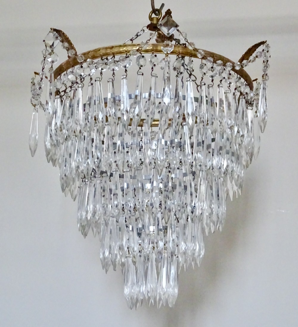 A FIVE TIER GLASS DROP CHANDELIER